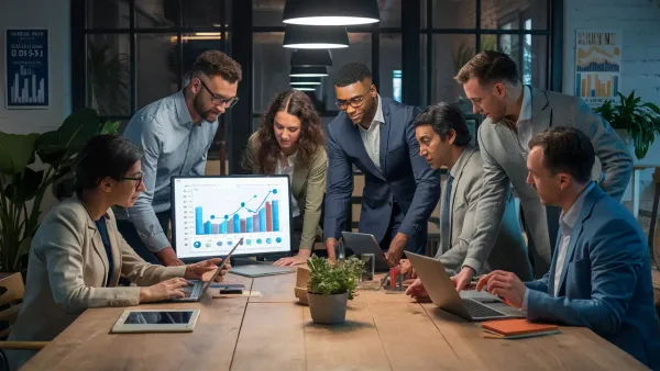 Equipe diversificada de profissionais analisando gráficos em uma sala de reuniões moderna.