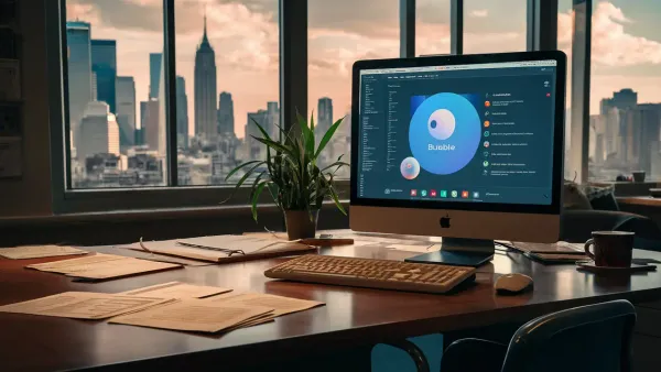 Computador com interface de aplicativo Bubble em uma mesa de escritório, com papéis, xícara e planta ao redor.